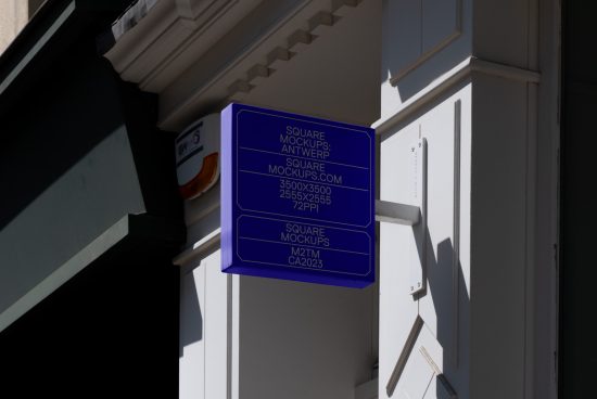 Blue mockup signboard on white building wall in sunlight, displaying mockup info and digital resolution details for designers.